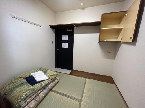 a room with a couch in a room with a door at Himawari-Kan Standard room Male only - Vacation STAY 74345v in Yokohama