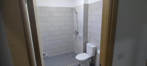 a small bathroom with a toilet and a shower at Logement familial 2 in Selouane