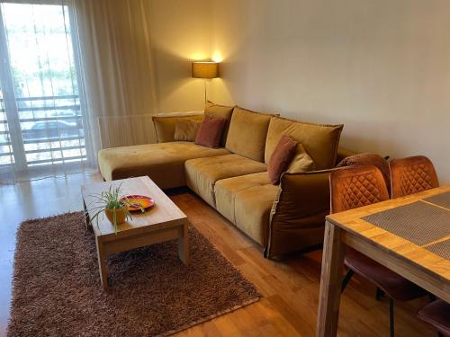 a living room with a couch and a table at Kuressaare Holiday Apartments in Kuressaare