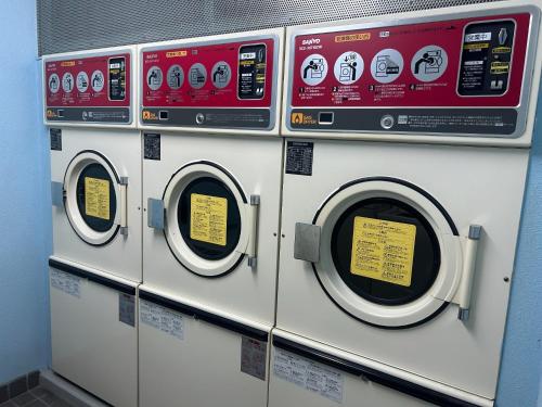 a row of washing machines in a laundromat at Himawari-Kan Standard room Female only - Vacation STAY 74387v in Yokohama