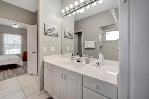 a white bathroom with a sink and a mirror at Tranquil Haven in Marco Island