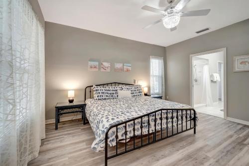 a bedroom with a bed and a ceiling fan at Tranquil Haven in Marco Island