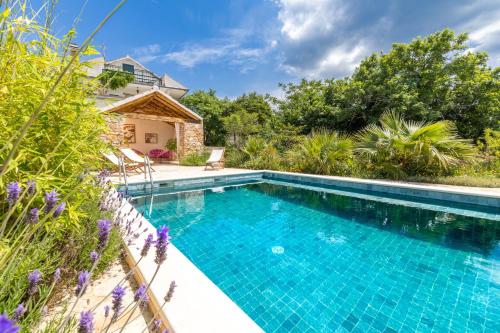 a swimming pool in the backyard of a villa at Mai's Cottage in Stari Grad