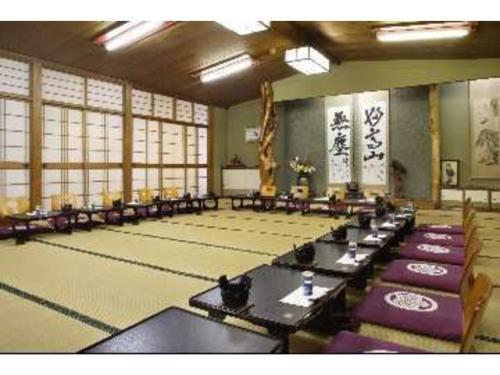a large room with tables and chairs and windows at Kofukan - Vacation STAY 67964v in Myoko