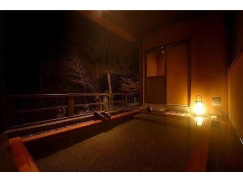 a light on the side of a house at night at Kofukan - Vacation STAY 67964v in Myoko