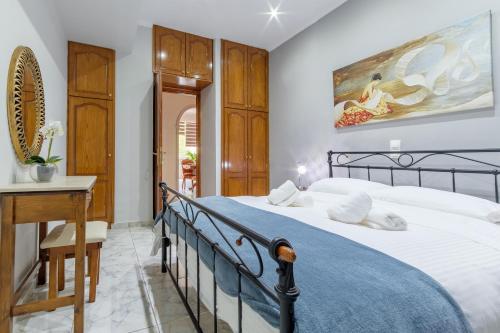 a bedroom with a bed and a table and a desk at Angela a la Corfu in (( Agía Eleoúsa ))