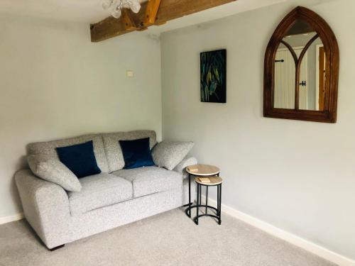 a living room with a couch and a table at The Annexe at Walnut Tree Cottage in Hope under Dinmore