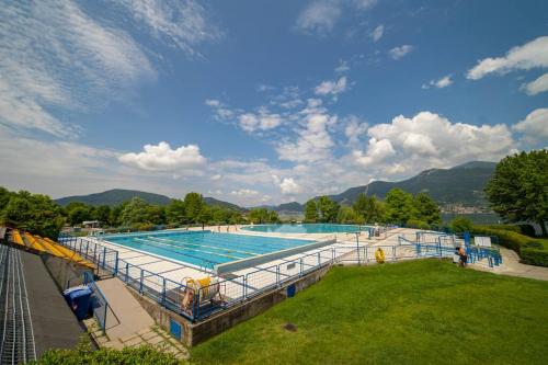 a large swimming pool on top of a building at Patio 15 - Pools, tennis and water sports in Iseo