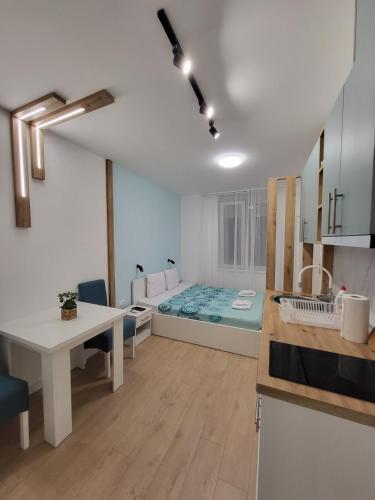 a living room with a bed in the middle of a room at HARMONY Suites (Savska ulica) in Sajmište