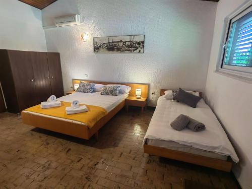 a bedroom with two beds and a window at Apartment Lada in Dramalj