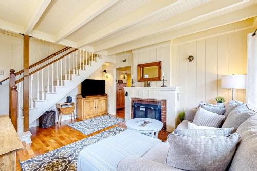 a living room with a couch and a fireplace at Seaside Beach By and By in Seaside