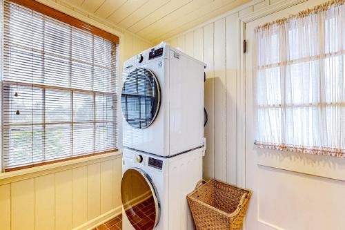 a washing machine in a room with a window at Seaside Beach By and By in Seaside