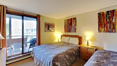a bedroom with a bed and a window with a balcony at 135 Marina Place in Dillon