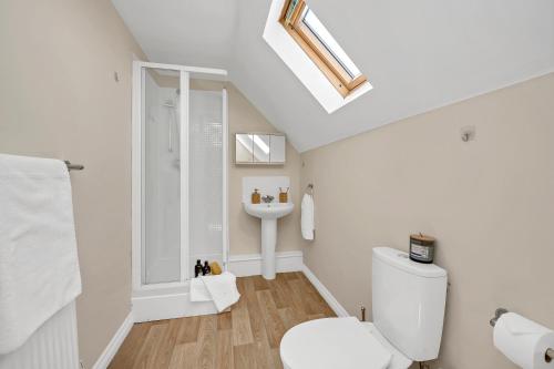 a bathroom with a white toilet and a sink at The Grange Luxe2, 5 Bedroom House,Spacious,contractor,family,Internet,free parking,group,study,relocation,easily accessible in Ipswich,Kesgrave in Ipswich