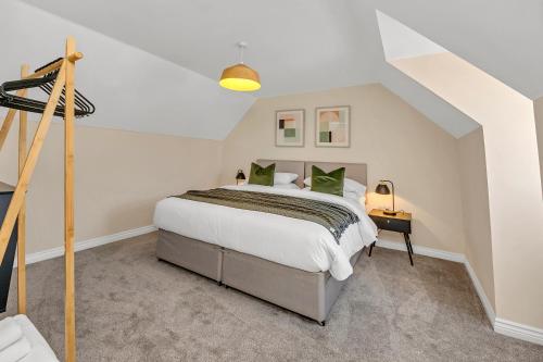 a bedroom with a large bed in a attic at The Grange Luxe2, 5 Bedroom House,Spacious,contractor,family,Internet,free parking,group,study,relocation,easily accessible in Ipswich,Kesgrave in Ipswich
