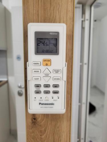 a remote control is attached to a door at HARMONY Suites (Savska ulica) in Sajmište