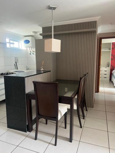a kitchen with a dining room table and chairs at APARTAMENT BEACH FORTALEZA in Fortaleza