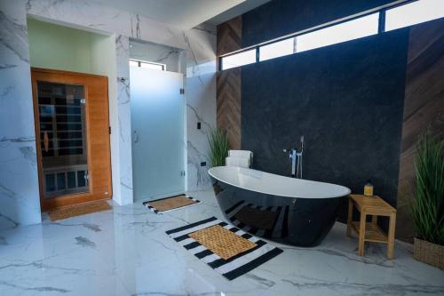 a bathroom with a large bath tub in a room at Casa Alvana in Ensenada