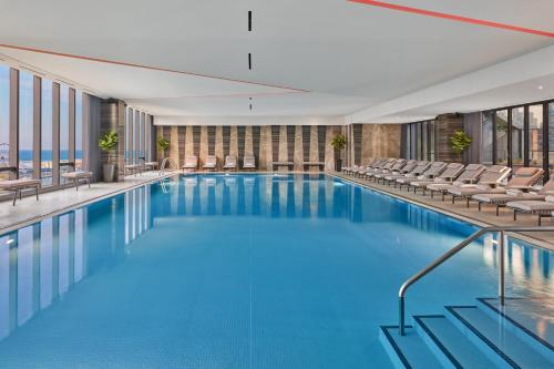 a swimming pool in a hotel with chairs at The St. Regis Chicago in Chicago