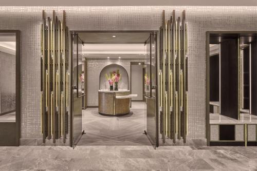 a lobby with a door with a vase of flowers at The St. Regis Chicago in Chicago
