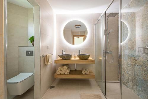 a bathroom with two sinks and a shower at Villa close to the beach. in Mijas