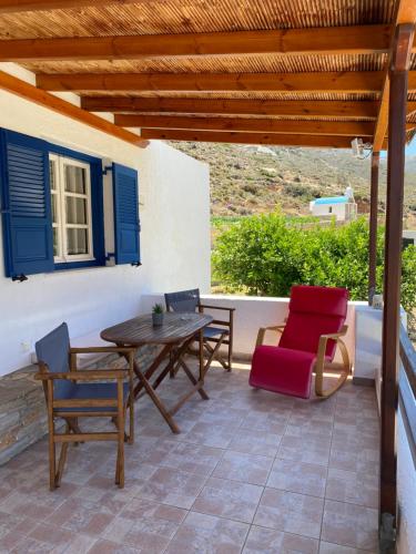 a patio with a table and chairs under a wooden roof at Dream Catcher 5 in Agia Theodoti