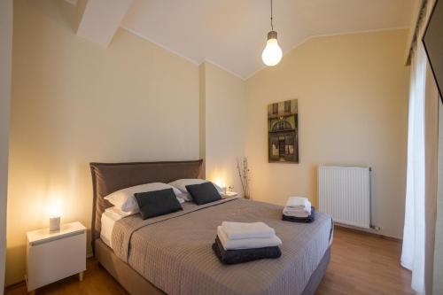 a bedroom with a bed with two towels on it at ioli Corfu maisonette in Kastanéa