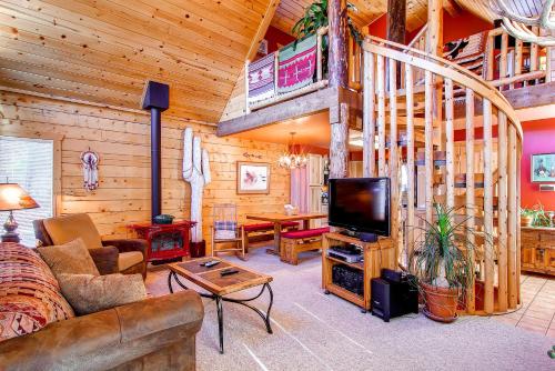 a living room with a couch and a tv in a cabin at 597 Deerpath in Dillon