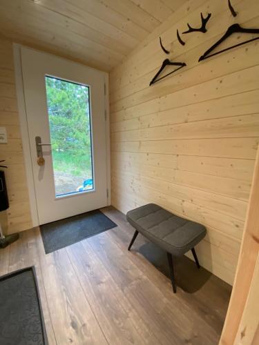 a room with a bench in a room with a window at Hengifosslodge Tiny Houses in Egilsstadir