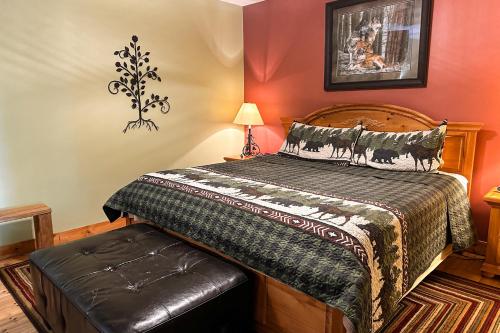 a bedroom with a bed and a bench in it at Pine Cone Cabin in Gatlinburg