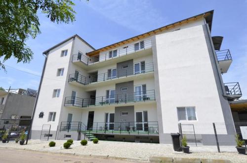 a large white building with balconies on it at Glow GuestHouse Costinesti in Costinesti