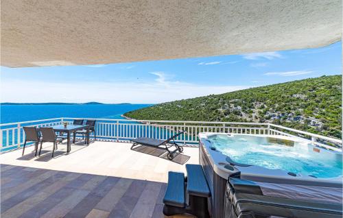 a swimming pool on a deck with a view of the water at Gorgeous Home In Vinisce With Jacuzzi in Vinišće