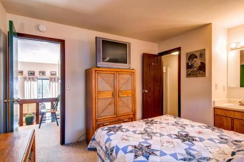 a bedroom with a bed and a television on a dresser at B-101 Buffalo Ridge in Silverthorne
