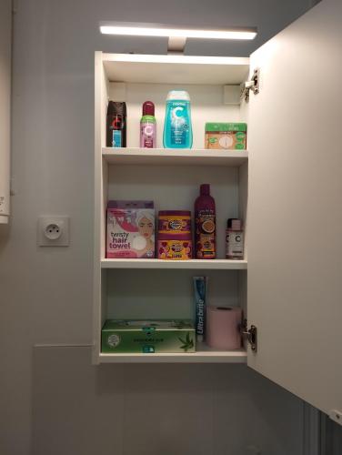 a bathroom shelf with food items on it at Studio Cosy en centre ville in Arpajon