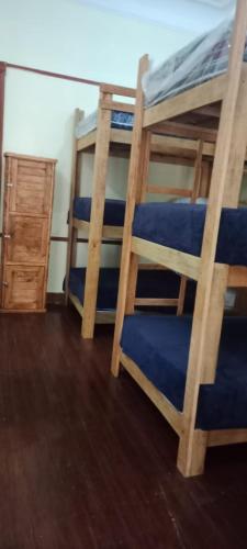 two bunk beds in a room with a wooden floor at Hostal T M in Mexico City
