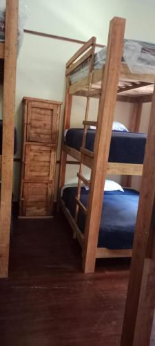 a room with two bunk beds and a ladder at Hostal T M in Mexico City