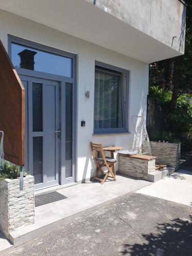 a house with a table and a glass door at Harmony apartments in Portorož