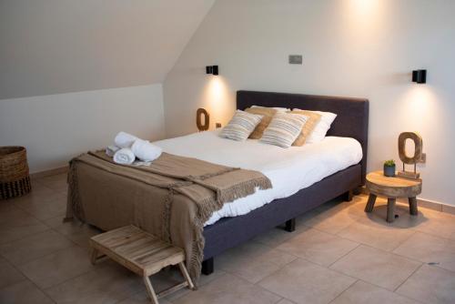 a bedroom with a large bed with towels on it at Boutique Hotel Het Zoete Zijn in Borgloon