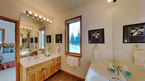 a bathroom with two sinks and a large mirror at 36 James Court in Dillon