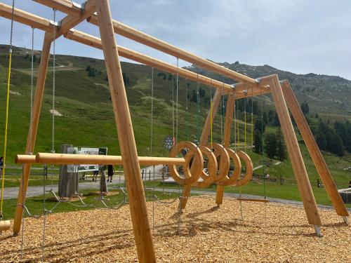 a playground with a wooden swing set at Gschlössle Ferienwohnungen in Jerzens