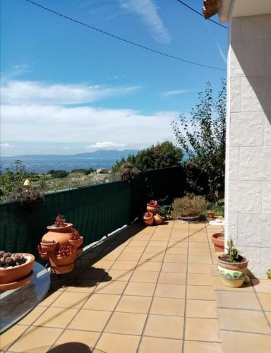 a patio with three vases on a fence at Casa de verano in O Grove