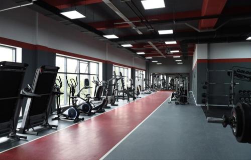 a gym with lots of treadmills and machines at Paradise in Lankaran