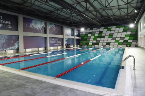 a large swimming pool in a large building at Paradise in Lankaran