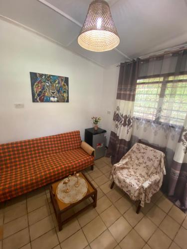 a living room with a couch and a table at Tradewinds Lodge in Diani Beach