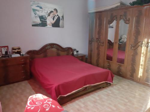 a bedroom with a bed and a large mirror at Liora's Vila in Laç