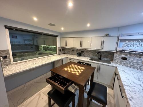 a kitchen with a wooden table and a sink at Mara Boutique Apartaments in Oldbury