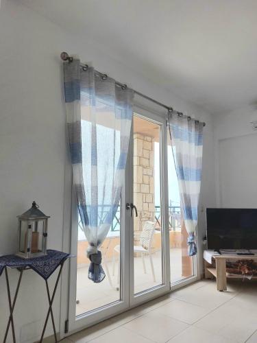 a room with a sliding glass door to a patio at Minoica Beach Apartments in Amoudara Herakliou