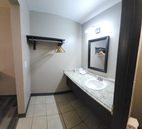 a bathroom with a sink and a mirror at Morada Inn in Anaheim