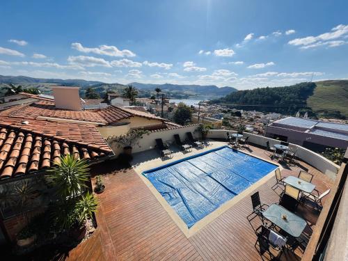 a swimming pool on the roof of a house at Pousada Quintal da Lua in Capitólio