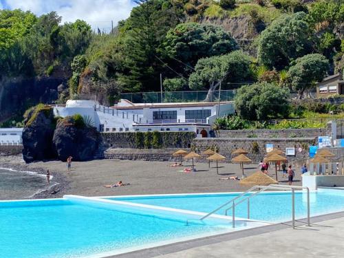 a resort with a swimming pool and a beach at Casa Xadrez in Povoação